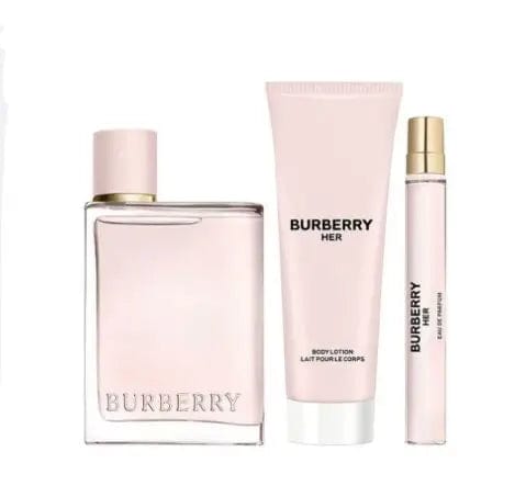 A beautifully laid-out product shot of the Burberry Her 3-piece gift set. The image shows the full-size Eau de Parfum bottle, the matching body lotion, and the convenient travel spray, all in their signature light pink color.
