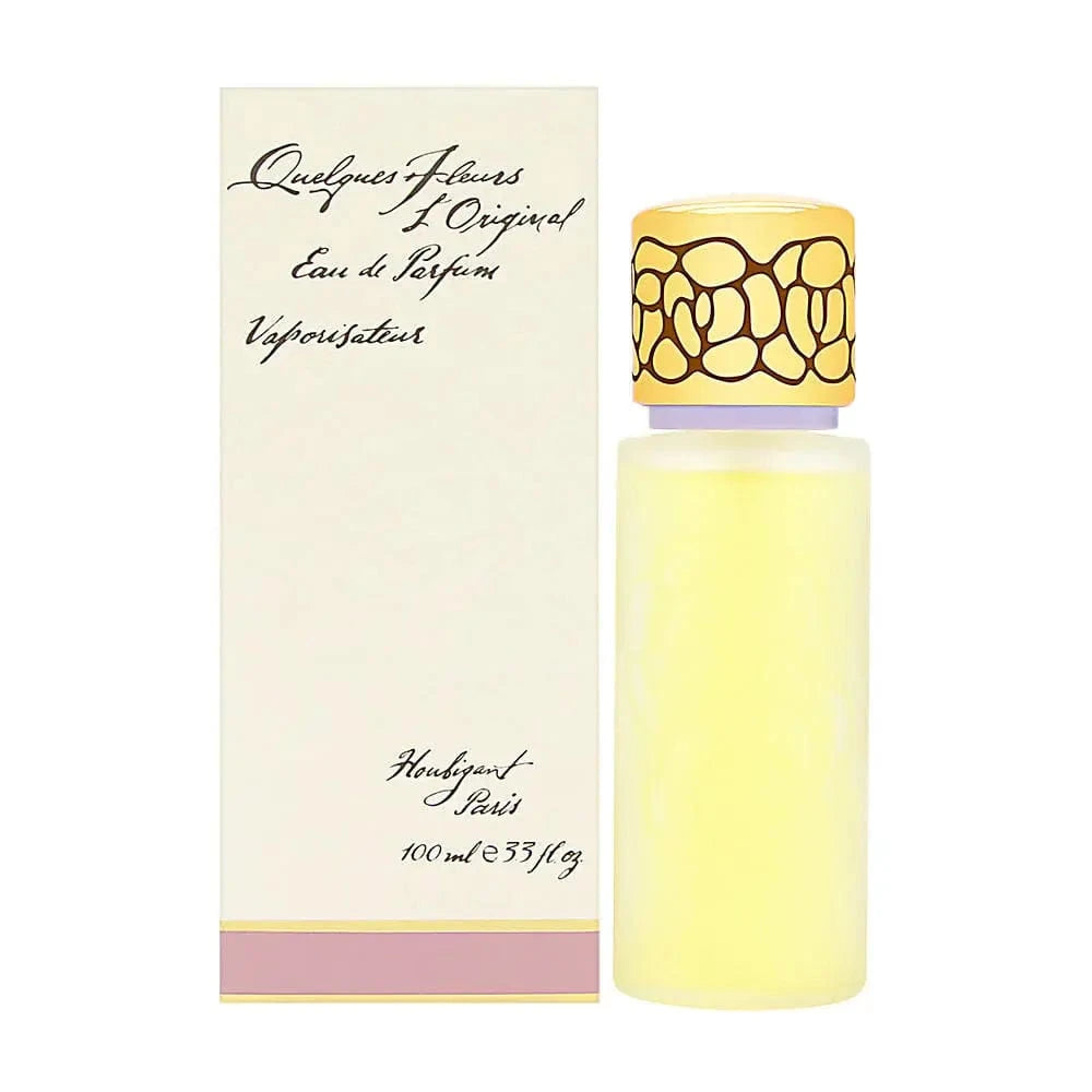 The Quelques Fleurs by Houbigant 3.3 oz EDP bottle, a clear cylinder with yellow liquid and an ornate gold cap, shown next to its elegant cream-colored box with script writing.