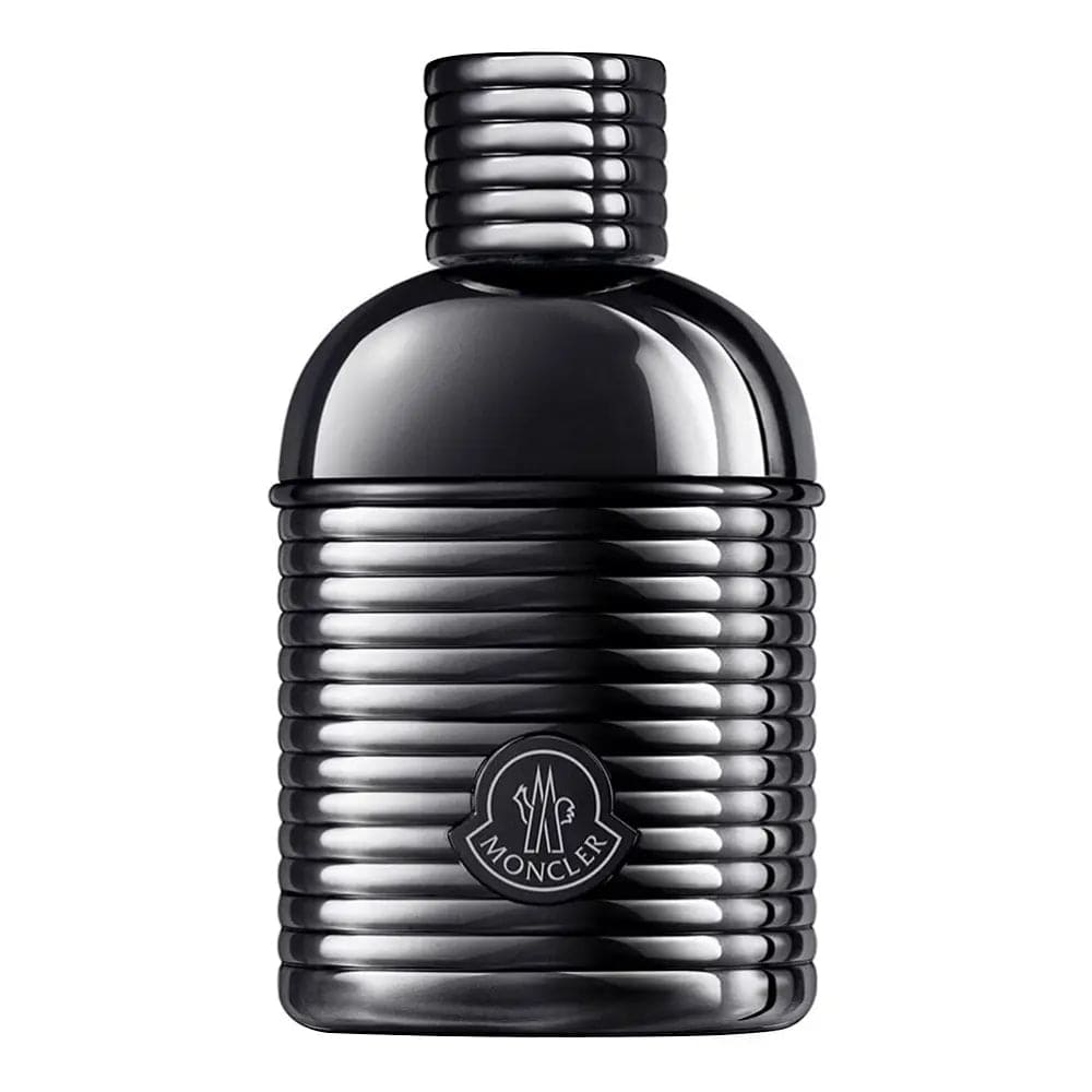 A professional, front-facing shot of the Moncler Sunrise Pour Homme perfume bottle, focusing on its distinctive ribbed texture and the embossed Moncler logo on the front.