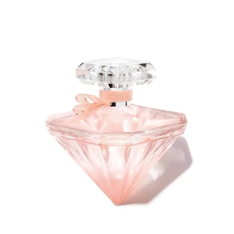 A clean product shot of the La Nuit Trésor Nude Eau de Toilette 3.4 oz bottle, highlighting its multifaceted diamond shape and pale pink ribbon.