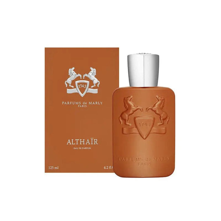 The Parfums De Marly Althaïr perfume bottle displayed next to its matching, beautifully designed box. The image highlights the complete product packaging, perfect for gifting, and emphasizes the brand&