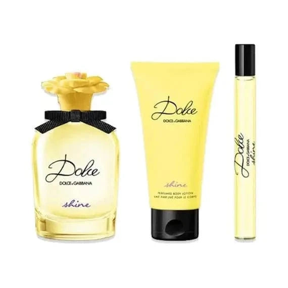 he Dolce Shine by Dolce &amp; Gabbana 3-piece gift set, including the EDP bottle with its yellow flower cap, a matching body lotion, and a travel spray.
