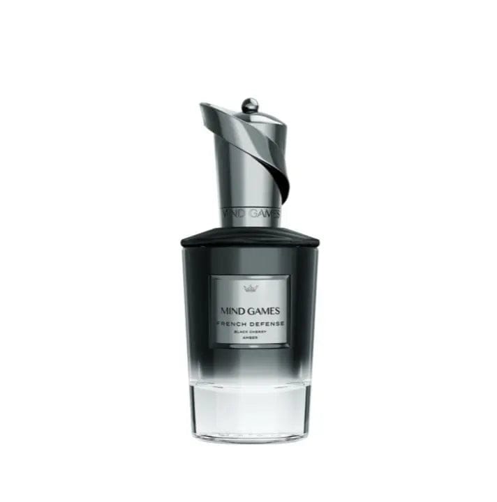 A professional close-up shot of the Mind Games French Defense perfume bottle, highlighting its intricate black and gold chess-piece cap. The bottle&