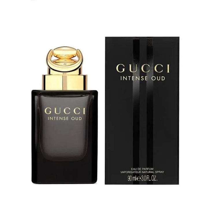 The Gucci Intense Oud 90ml EDP bottle shown next to its elegant, minimalist black presentation box with matching gold text.