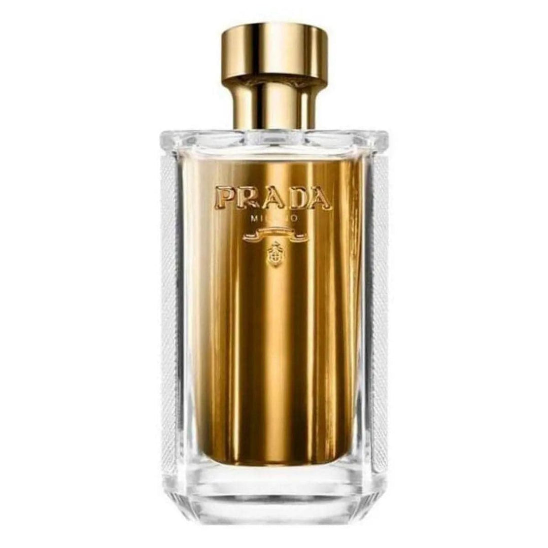 The luxurious La Femme Prada 3.4 oz EDP bottle, showing its gold-tone front and white Saffiano leather-textured side.