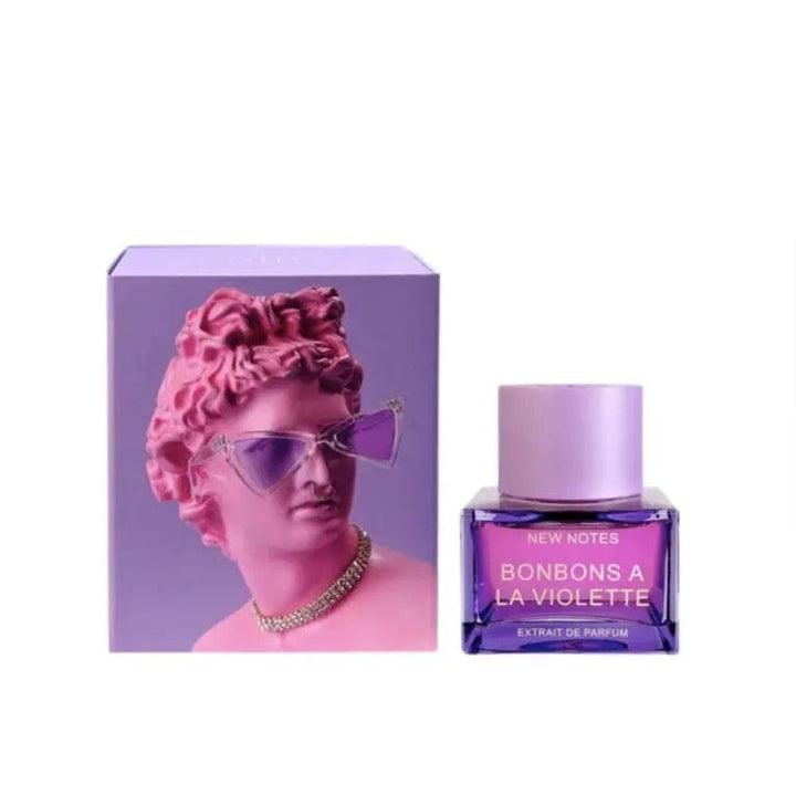 The New Notes Bonbons A La Violette Extrait de Parfum bottle displayed next to its artistic lavender-colored box, which features a purple classical bust wearing modern sunglasses.