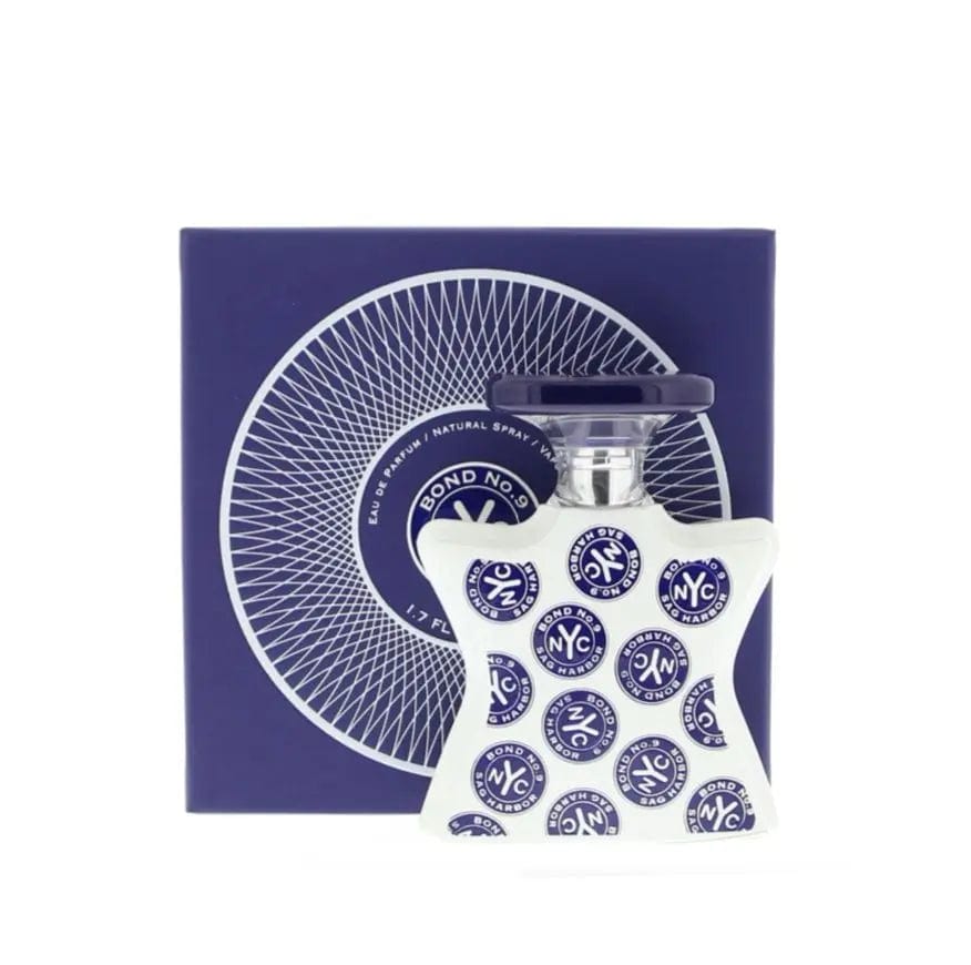 The Bond No. 9 Sag Harbor bottle shown in front of its dark blue presentation box, which features a white 'spoke' design.