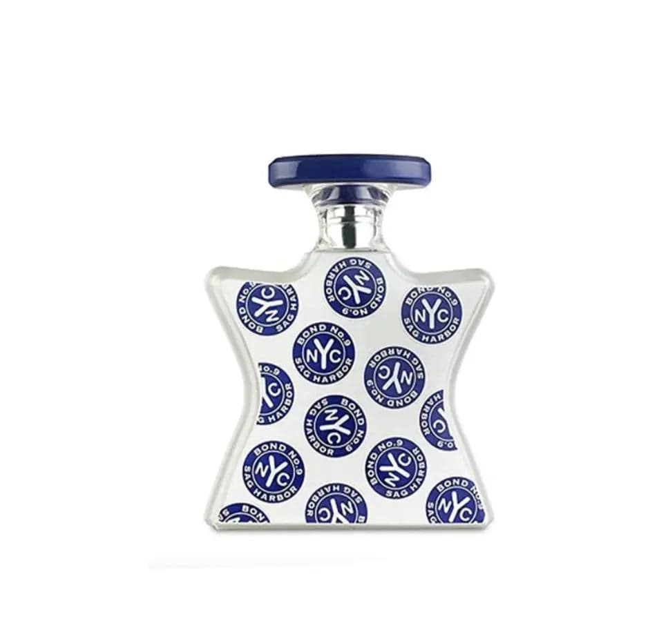 A clean product shot of the Bond No. 9 Sag Harbor 3.3 oz EDP, showing its star-shaped bottle decorated with blue and white 'NYC' logos and a blue cap.
