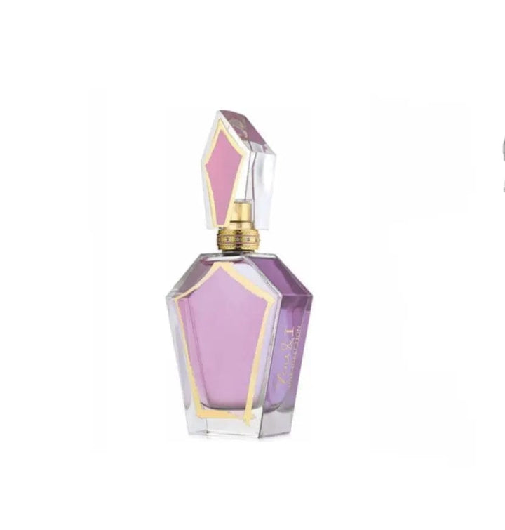 A close-up shot of the You &amp; I One By Direction perfume bottle for women, showing its elegant design and the vibrant pink liquid inside.